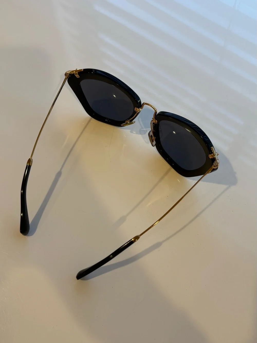 Miu Miu Classic Black Cat-Eye Sunglasses with Gold Accents
